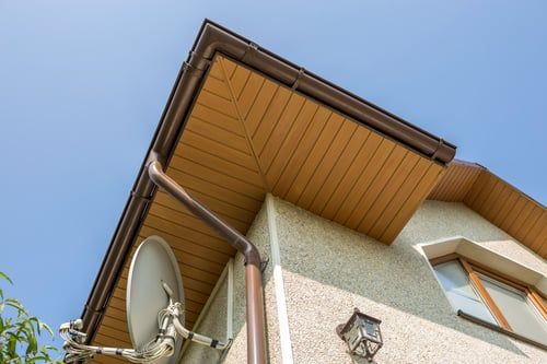 Seamless gutters installed along a North Carolina roofline by Vega Drywall Services